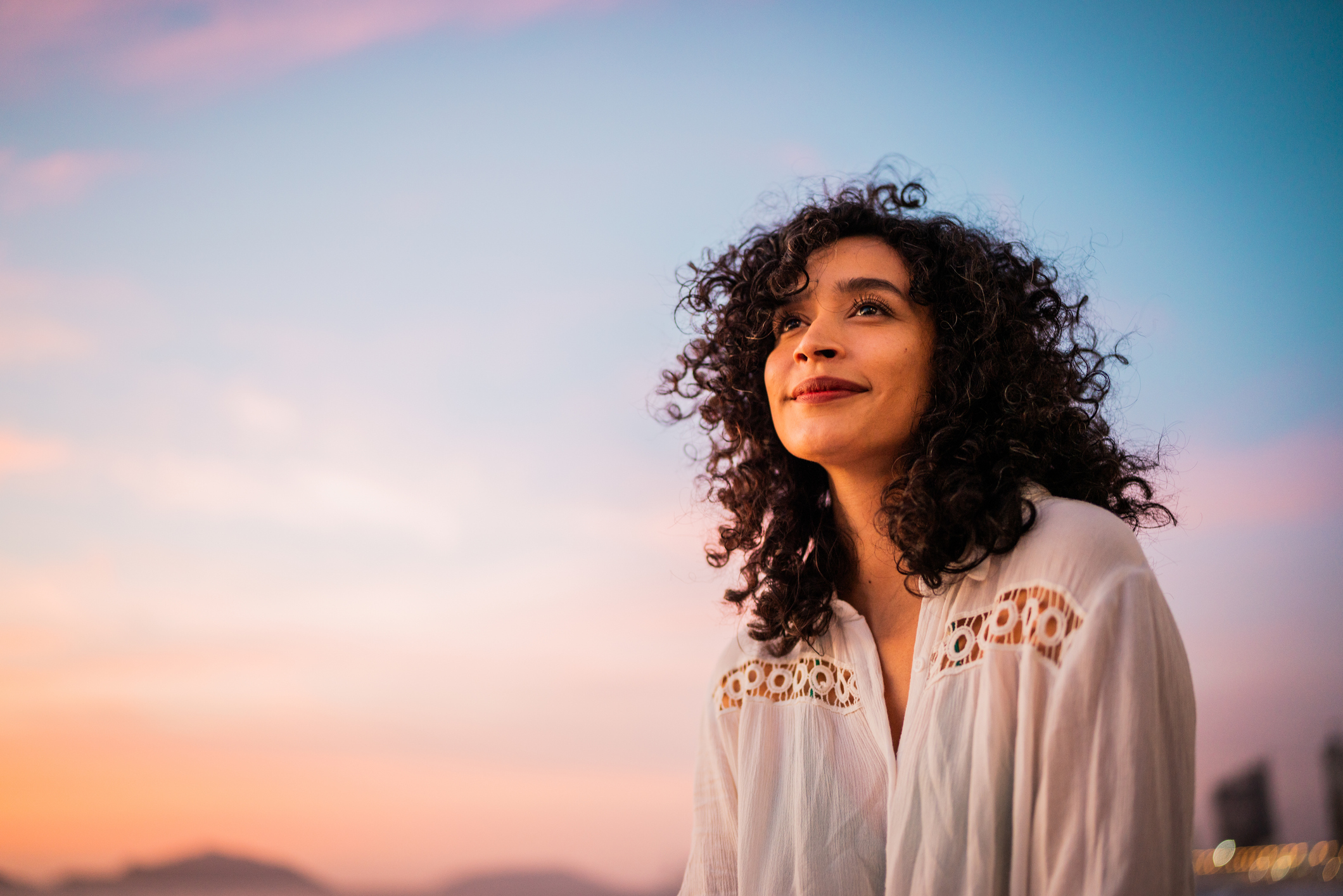 Young adult woman looking up with clarity during golden hour
